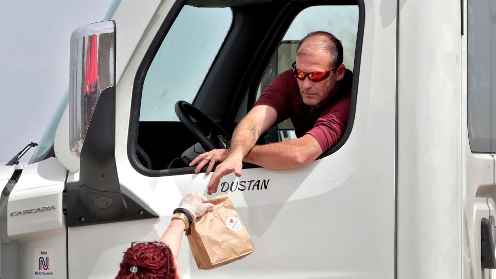 An Arizona Trucking Association volunteer gives a free lunch to a truck driver, at a rest area along I-10 in Sacaton, Ariz. The group was giving away 500 lunches from Dilly's Deli to westbound truck drivers in appreciation for delivering medical supplies, food, and other necessities during the COVID-19 coronavirus pandemic. The new coronavirus causes mild or moderate symptoms for most people, but for some, especially older adults and people with existing health problems, it can cause more severe illness or deathVirus Outbreak Arizona Truckers, Sacaton, United States - 31 Mar 2020