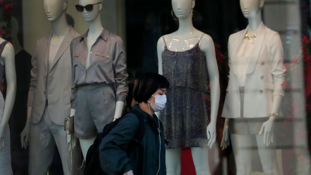 Woman wearing a face mask walks past a closed shop on Oxford Street in London, as the country is in lockdown to help curb the spread of the coronavirus, . Experts in the UK have warned that the economy could shrink by up to 35% as a knock on effect of the lockdown. The highly contagious COVID-19 coronavirus has impacted on nations around the globe, many imposing self isolation and exercising social distancing when people move from their homesVirus Outbreak Economy, London, United Kingdom - 15 Apr 2020