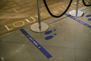 Floor stickers in front of the Louis Vuitton shop-in-shop at the Galeries Lafayette flagship on Boulevard Haussmann in Paris.