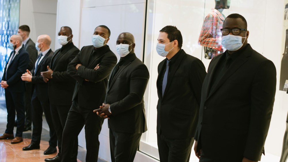 Security guards wait to greet shoppers at the Galeries Lafayette flagship on Boulevard Haussmann in Paris.