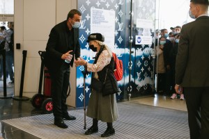 The first shopper walks through the doors at the re-opening of the Galeries Lafayette flagship on Boulevard Haussmann in Paris.