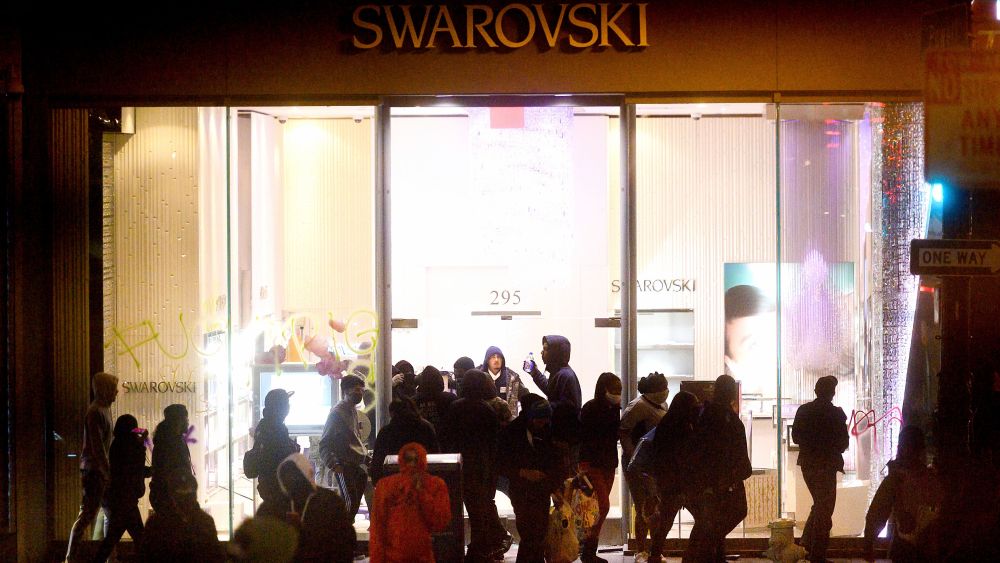 People vandalize a Swarovski store in San Francisco's Union Square.