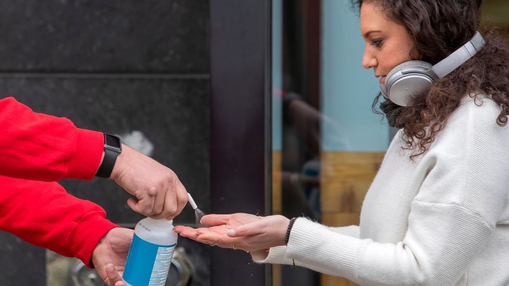 A customer receives a squirt of hand sanitizer from an employee before entering a Trader Joe's grocery store in Washington, DC, USA, 31 March 2020. District of Columbia Mayor Muriel Bowser has issued a 'stay-at-home' order to take affect 01 April 2020. The spread and containment efforts of the coronavirus COVID-19 pandemic has caused disruptions to daily life across the globe.Coronavirus COVID-19 reactions in Washington, DC., USA - 31 Mar 2020