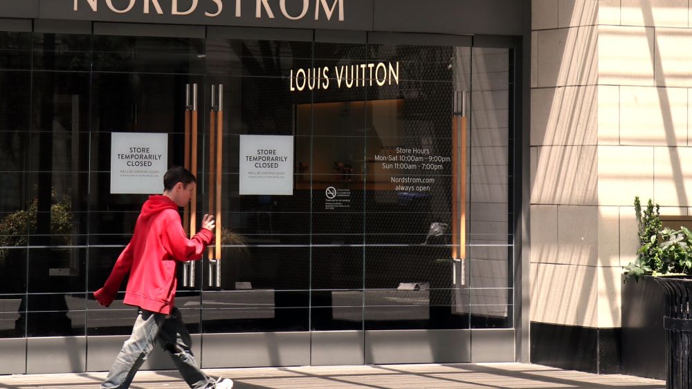 man walks by closed nordstrom store in seattle