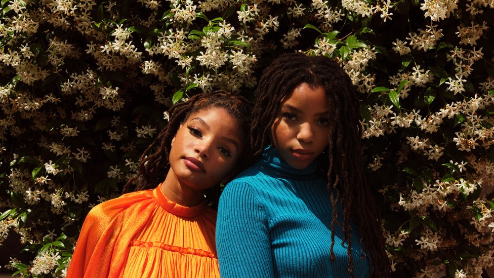 Chloe in Carolina Herrera's plaited rib tie turtleneck and flare skirt. Halle in Carolina Herrera's cape minidress.