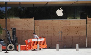 Workers board up an Apple store in Walnut Creek, California.