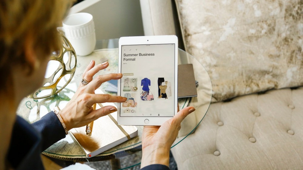 Caucasian woman shopping for clothing on digital tablet (Blend Images via AP Images)