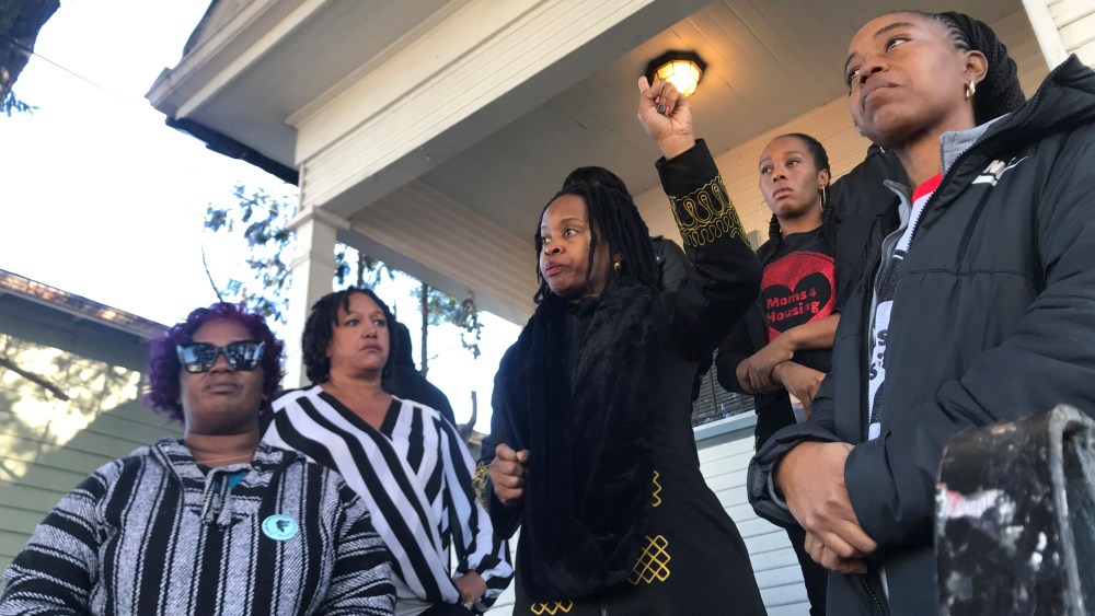 In this photo taken Dec. 30, 2019, Sharena Thomas, left, Carroll Fife, center, Dominique Walker, second from right, and Tolani KIng, right, stand outside a vacant home on Magnolia Street in West Oakland, Calif. The group Moms 4 Housing is fighting an eviction after occupying the house since November. The women took over the home after they said they were unable to find permanent housing in the Bay Area, where high-paying tech jobs have exacerbated income inequality and a housing shortage. (Kate Wolffe/KQED via AP)
