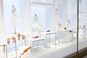 Fine jewelry by Victoire de Casellane is displayed on tiny tables in a vitrine.