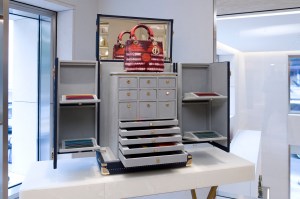 A trunk displays hardware and leather options for custom handbags.