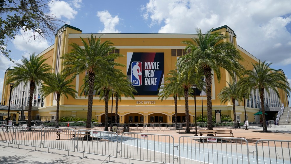 An NBA sign is posted on a basketball arena at ESPN Wide World of Sports Complex in Orlando, Fla., where NBA games resumed July 30.