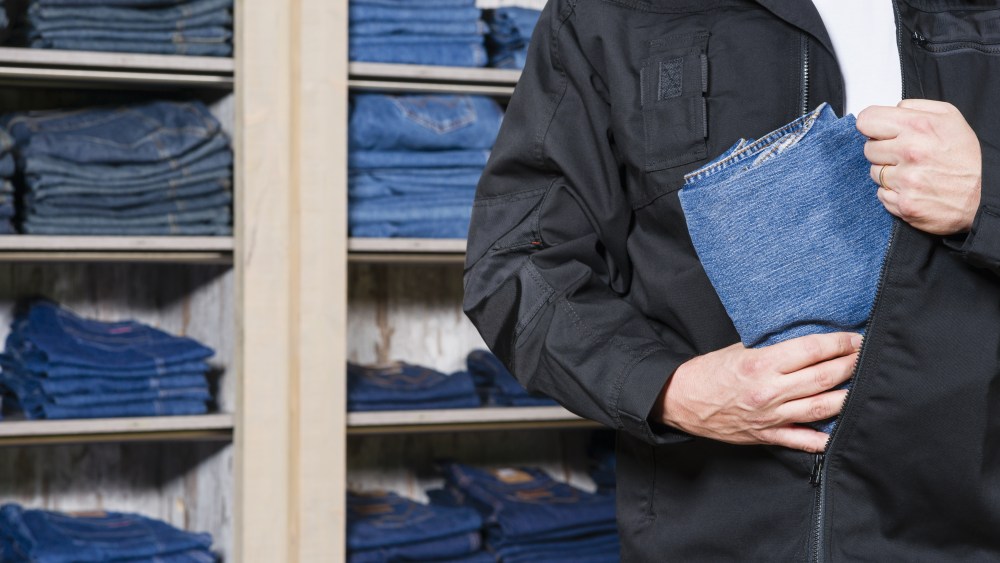 man stealing jeans