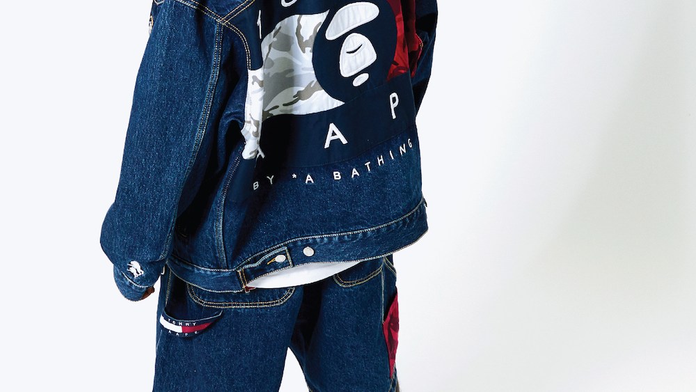 The Tommy Jeans X AAPE By A Bathing Ape capsule collection will drop July 11 and feature nostalgic ‘90s denim streetwear looks.