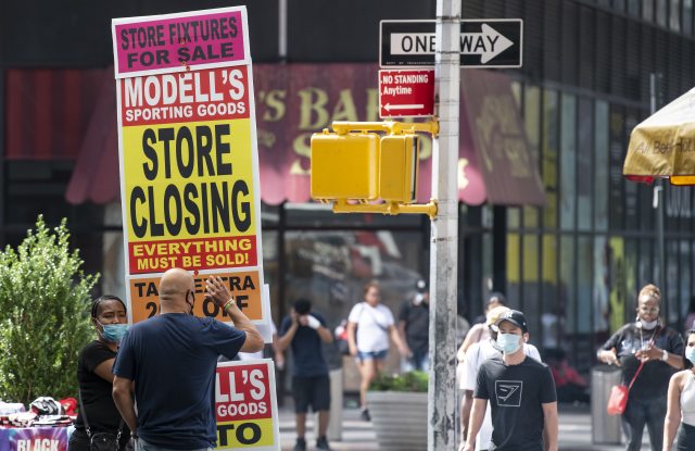 August 08, 2020: An overall view of a Mid-Town street corner with a person holding a store closing sign as business struggle to stay in business in Manhattan, New York. Mandatory credit: Kostas Lymperopoulos/CSM (Credit Image: © Kostas Lymperopoulos/CSM via ZUMA Wire) (Cal Sport Media via AP Images)