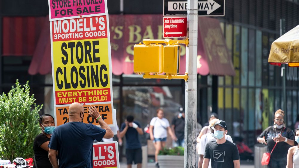 August 08, 2020: An overall view of a Mid-Town street corner with a person holding a store closing sign as business struggle to stay in business in Manhattan, New York. Mandatory credit: Kostas Lymperopoulos/CSM (Credit Image: © Kostas Lymperopoulos/CSM via ZUMA Wire) (Cal Sport Media via AP Images)