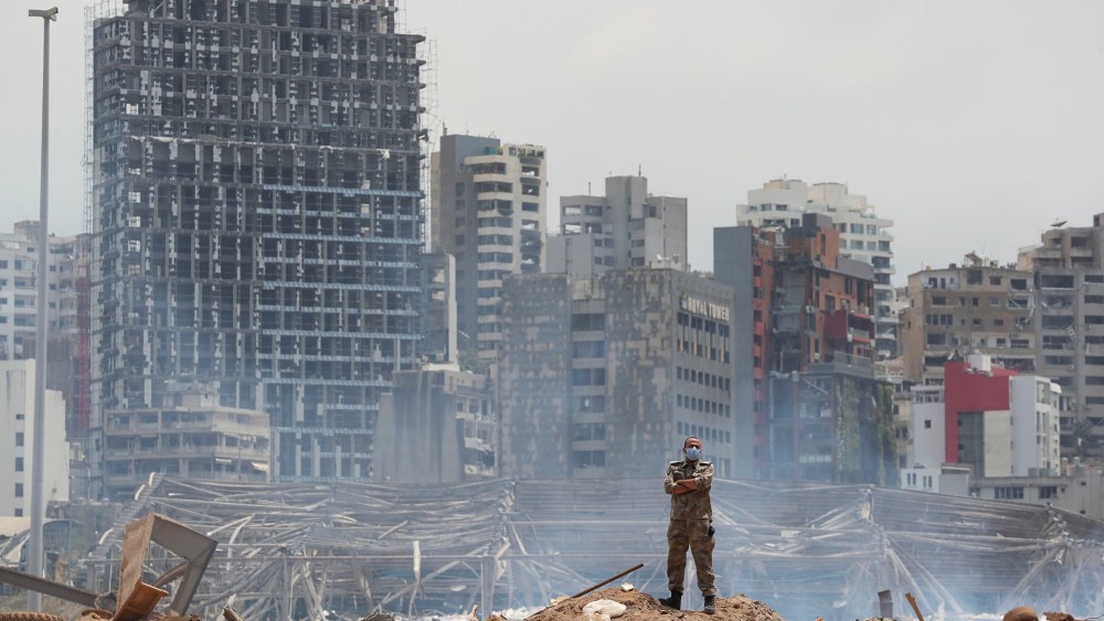 A soldier stands at the devastated site of the explosion in the port of Beirut, Lebanon, Thursday, Aug. 6, 2020. French President Emmanuel Macron came in Beirut to offer French support to Lebanon after the deadly port blast. (AP Photo/Thibault Camus, Pool)