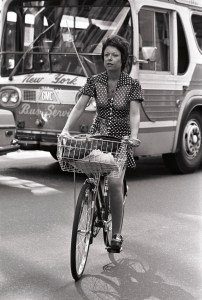 A woman riding a bicycle on the street in New York, 1973.