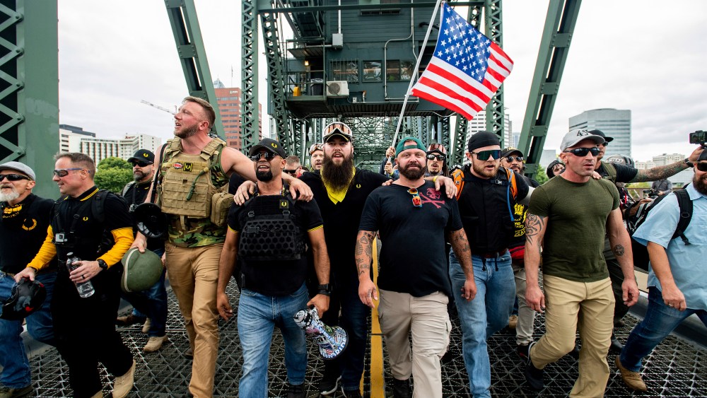 Members of the Proud Boys and other right-wing demonstrators march across the Hawthorne Bridge during a rally in Portland.