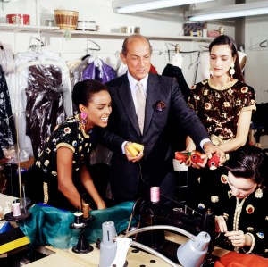 Designer Oscar de la Renta poses with models in his New York design studios, 1990.