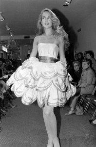 Model Jerry Hall poses in a three layered flounce cocktail dress for Oscar de la Renta spring 1980.