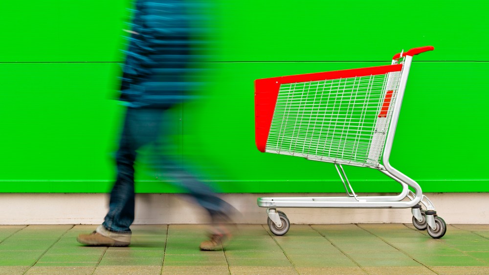 Man walking by empty shopping trolley. (Photo by: SCIENCE PHOTO LIBRARY via AP Images)