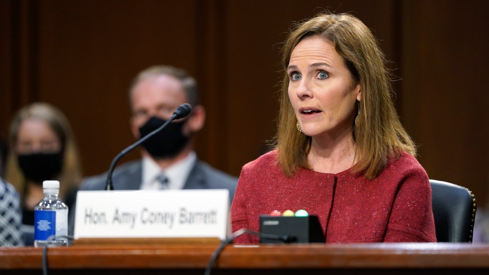 Supreme Court nominee Amy Coney Barrett speaks during a confirmation hearing before the Senate Judiciary Committee, Tuesday, Oct. 13, 2020, on Capitol Hill in Washington. Her family looks on at left. (AP Photo/Patrick Semansky, Pool)
