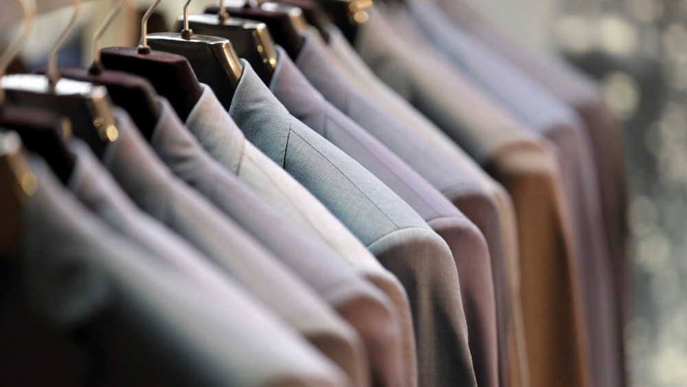 Row of men's suits hanging on hanger