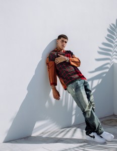 Loewe's wool sweater and Heron Preston x Levi's cotton denim jeans, available at The Webster Bal Harbour Shops. Nike sneakers.