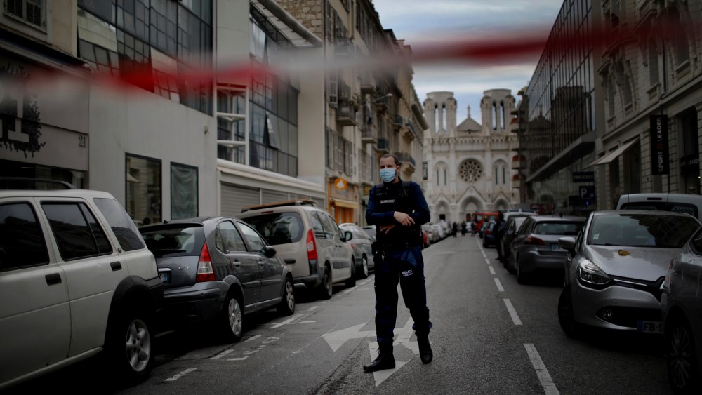 A French policeman stands guard near the scene of the knife attack at the Notre Dame church in Nice, France.
