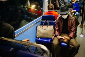 Stylish commute in Paris. Since (in theory) only every second chair on the metro should be occupied, putting your bag next to you was not something to be frowned upon. It could even be seen as a justified mean of keeping secure distance.
