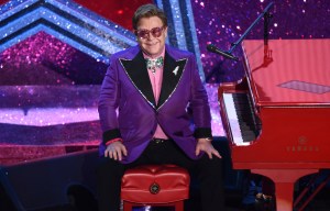 FILE - In this Sunday, Feb. 9, 2020, file photo, Elton John is seen after performing "(I'm Gonna) Love Me Again," nominated for the award for best original song from "Rocketman" at the Oscars at the Dolby Theatre in Los Angeles. John hosted an hour-long, live benefit concert special put on to raise money during the coronavirus crisis, Sunday, March 29, 2020, on Fox and iHeartMedia radio stations. (AP Photo/Chris Pizzello, File)