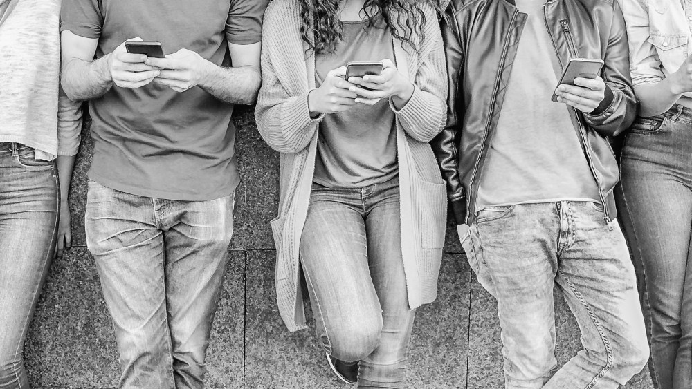 Group of friends using their smart mobile phones - Millennial young people addicted to new technology trends app - Concept of people, tech, social media, generation z and youth lifestyle