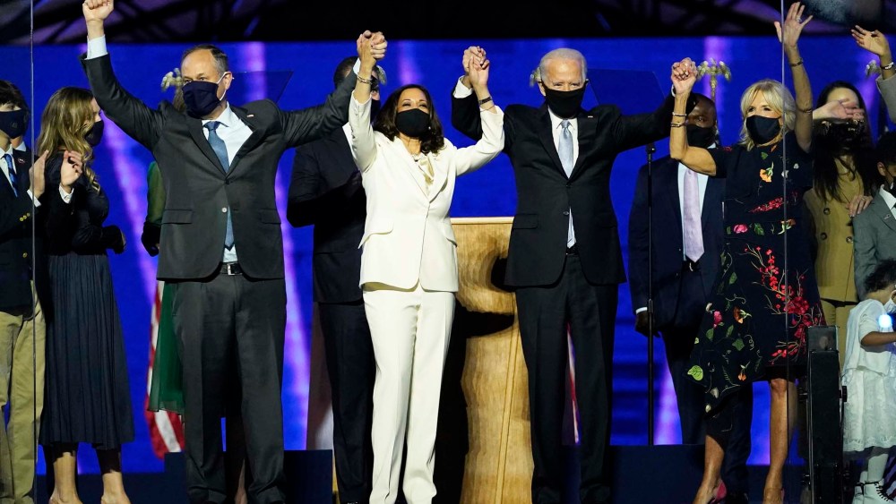 From left, Doug Emhoff, husband of Vice President-elect Kamala Harris, Harris, President-elect Joe Biden and his wife Jill Biden on stage together, Saturday, Nov. 7, 2020, in Wilmington, Del.