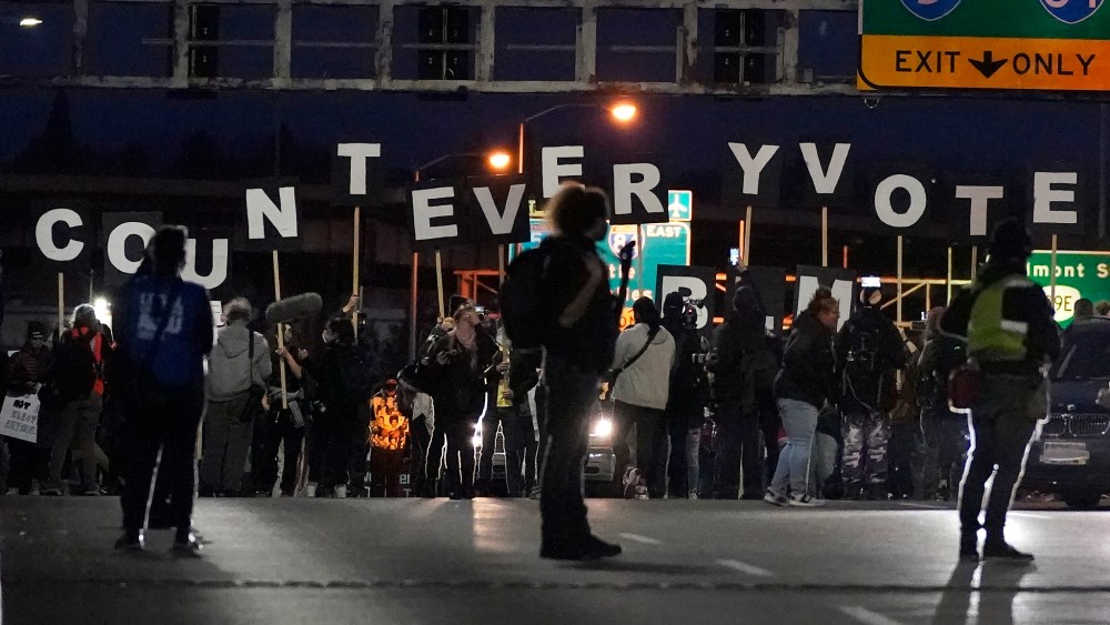 Protesters hold letters that spell Count Every Vote as they cross an overpass while marching in Portland on Wednesday, Nov. 4, 2020.