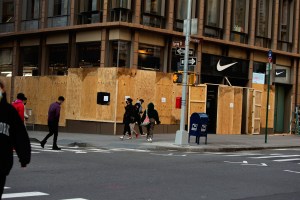 Boarded up stores across SoHo in New York .