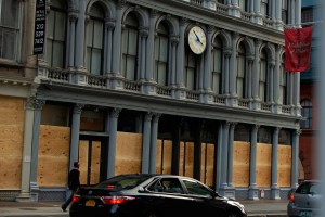 Boarded up stores across SoHo in New York .