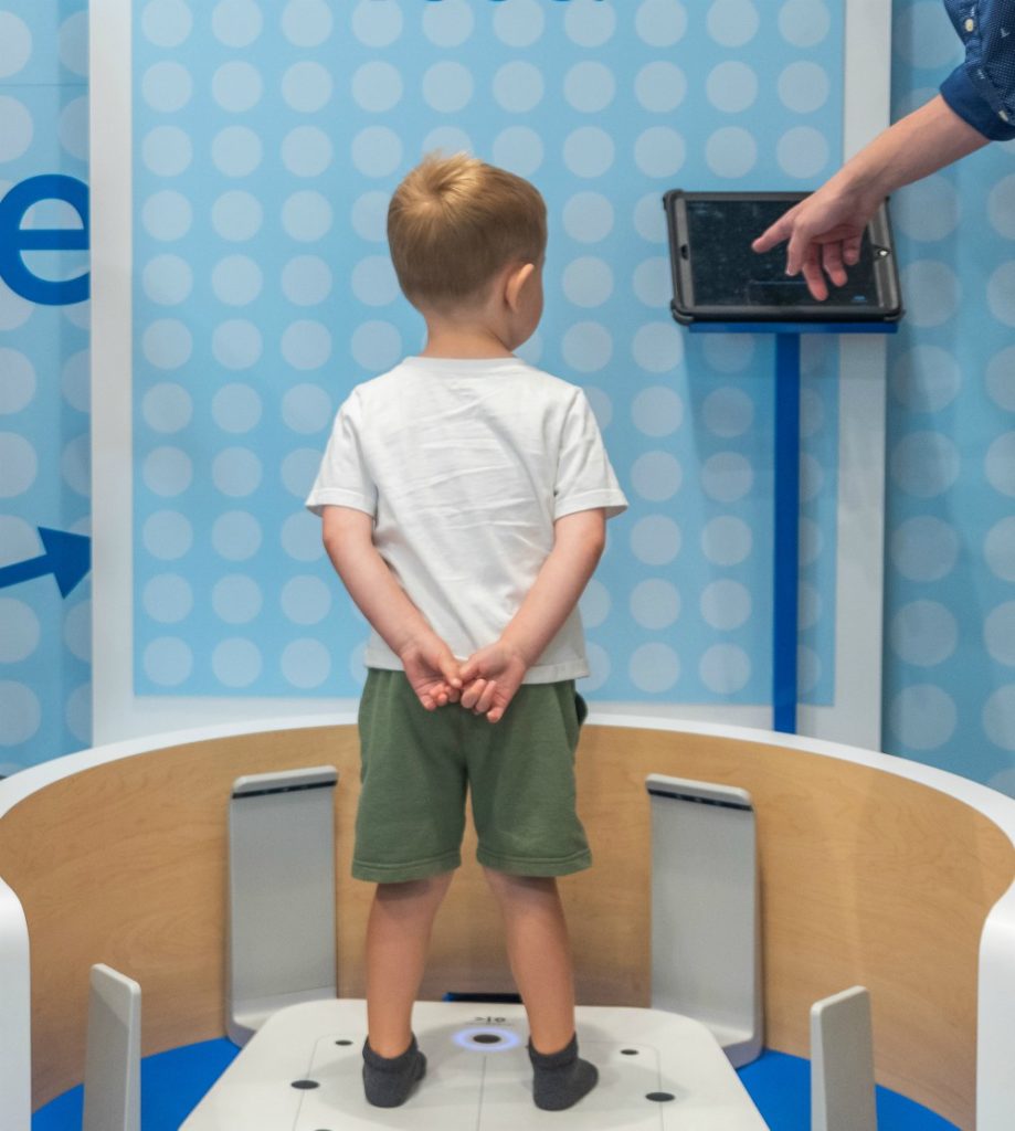 A child uses Stride Rite's Fit Zone technology to scan his feet