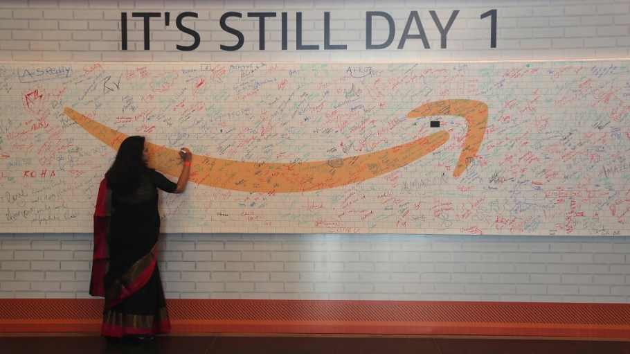 An Indian employee signs a board in the premises of Amazon's then-newly inaugurated campus building in Hyderabad, India, Wed., Aug. 21, 2019.