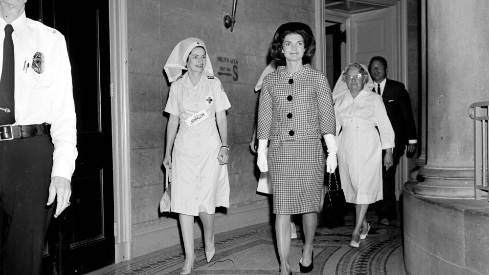 Jackie Kennedy and Red Cross Nurses arrive for a luncheon at the White House.