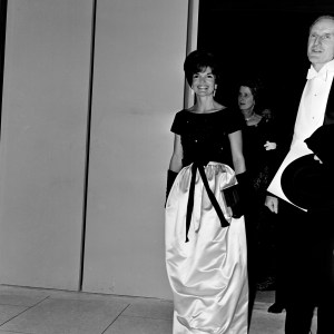 First Lady Jacqueline Kennedy and guest arrive for a performance at Lincoln Center for the Performing Arts in New York City on September 23, 1962. The First Lady wears a dress designed by Oleg Cassini.