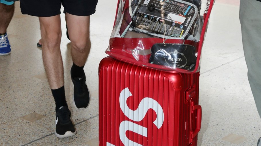 Lily Allen pictured arriving in Sydney sporting Supreme luggage. VF snapped up the streetwear label for $2.1 billion.