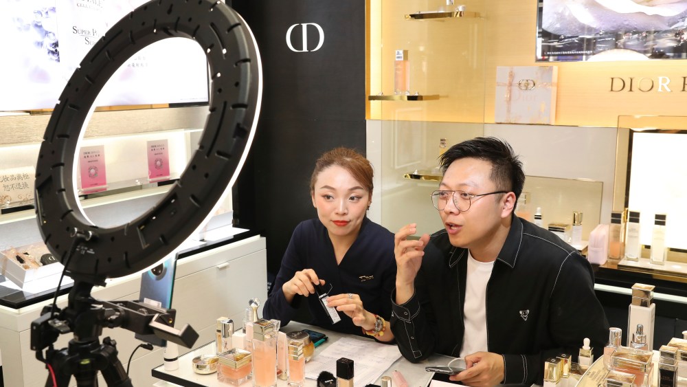 Salesmen do live-streaming at a shopping mall in Congchuan district, Nantong city, east China's Jiangsu province.