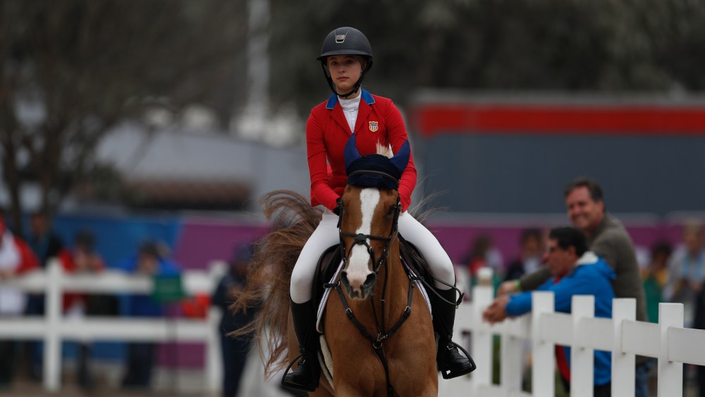 Eve Jobs of the U.S. warms up her horse Venue d'Fees des Hazalles as she prepares to compete in the first classification round of individual and team equestrian jumping at the Pan American Games in Lima, Peru, Tuesday, Aug. 6, 2019. (AP Photo/Rebecca Blackwell)