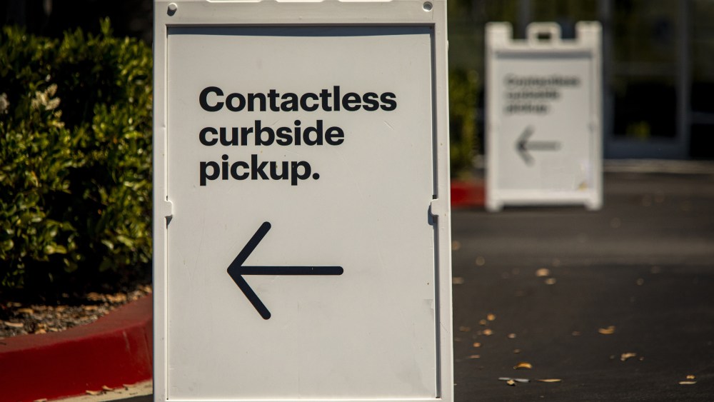 Sign advertising Contactless Curbside Pickup at retail store parking lot