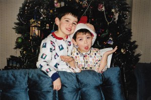 "I have attached a photo of me (on right) in my favorite bear and plaid flannel pajamas and my brother, Brian on Christmas Day 1997. 

I have so many memories, as my Mom really always made Christmas special. I think I definitely inherited the Christmas Decorating bug for her. 

1.) My mom would always cook a Bacon and Egg Christmas morning breakfast after we exchanged gifts. This would be the only time all year we would eat bacon, and still to this day whenever I smell bacon, it transports me back to my parents house and Christmas Morning. 

2.) My grandfather would sleep over my house on Christmas Eve to be with us on Christmas morning and see us open our gifts. He would sleep on a bed, in me and my brother's bedroom closest to the door. Me and my brother would always wake up so early with excitement and love to check what Santa left , and we would crawl under the bedframe of his bed to get to the door to run downstairs and look at what Santa left us. As we got older we were too big to crawl under the bed frame and we would quietly and carefully crawl on top of my sleeping grandfather to go downstairs making sure not to wake him up. It was the ultimate Christmas Morning game, and I'm proud to say neither of us awoke him in the many years we did that maneuver." - Colin Locascio