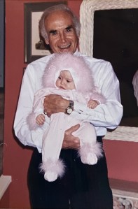 "We celebrate Channukah and Christmas in my family. Around the holidays my aunts, uncles, cousins and grandparents would get together and my grandfather, Papa Sugarman, who would hand out presents, which he would solely refer to in his thick Boston accent as Òprizes." One of the most memorable prizes was a full-body pink onesie with faux sparkled feather accents on the hood, ankles and cuffs. Although I was too young to actually remember receiving the gift, this garment, to this day remains hanging in my closet. And no matter what time of year, every time I look at it makes me smile and think of my Papa."- Ella Wiznia, The Series