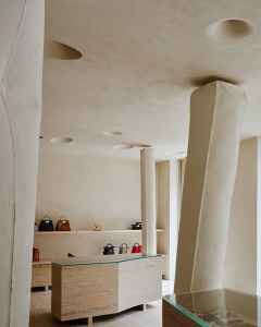 Handbags and small leather goods are displayed near the entrance to the boutique.