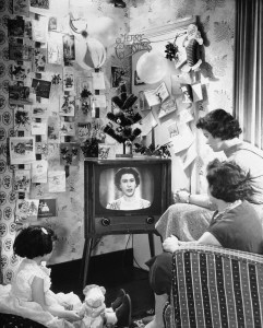 A London family looks at Queen Elizabeth II on a television screen during her majesty?s first Christmas day telecast to the British people on Dec. 26, 1957.   Listening to the Queen are Mrs. Sidney Smart and her daughters, Sandra, 4, left, and Barbara, 15, right.  (AP Photo)