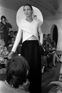 A model wearing a black-and-white dress with an elaborate high-collar wrap in the Cardin couture fall 1973 show in Paris.