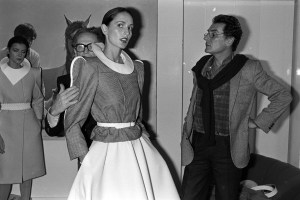 Designers Andre Oliver and Pierre Cardin fit models at the preview for the 1980 couture collection